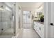 Primary bathroom featuring a tiled shower and dual vanities at 9759 Waco St, Commerce City, CO 80022