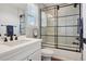 Bright bathroom featuring black hardware, a shower-over-tub and a white vanity at 9759 Waco St, Commerce City, CO 80022