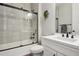 Bathroom with walk-in shower, white cabinets, and black accents at 9759 Waco St, Commerce City, CO 80022