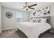 Comfortable bedroom featuring a tufted headboard, a ceiling fan and neutral-toned walls at 9759 Waco St, Commerce City, CO 80022