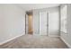 Minimalist bedroom featuring neutral walls, carpeted floor, and window with natural light at 9759 Waco St, Commerce City, CO 80022