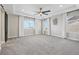 Large primary bedroom with a tray ceiling, neutral paint, and carpeted floors at 9759 Waco St, Commerce City, CO 80022