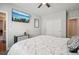 Relaxing bedroom featuring a ceiling fan, closet, accent mirror, and television for ultimate comfort at 9759 Waco St, Commerce City, CO 80022
