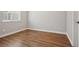 Empty bedroom showcasing wood laminate floors, white trim and neutral walls at 9759 Waco St, Commerce City, CO 80022