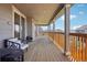 Large deck with wood flooring and wooden railings offering views of the surrounding neighborhood at 9759 Waco St, Commerce City, CO 80022