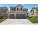 Traditional two-story home featuring a three-car garage and inviting curb appeal at 9759 Waco St, Commerce City, CO 80022