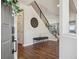 An inviting home foyer featuring hardwood floors, staircase and modern decor at 9759 Waco St, Commerce City, CO 80022