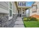 Inviting front porch with stone accents and manicured landscaping at 9759 Waco St, Commerce City, CO 80022