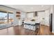 Bright eat-in kitchen with a large center island, stainless appliances, and slider doors to the outdoor deck at 9759 Waco St, Commerce City, CO 80022