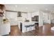 Modern kitchen featuring stainless steel appliances, island with seating, and wood flooring at 9759 Waco St, Commerce City, CO 80022