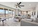 Spacious living room with stylish furniture, connecting to the kitchen and deck with sliding glass doors at 9759 Waco St, Commerce City, CO 80022