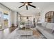 Open-concept living room with modern decor, connecting to the kitchen, and sliding glass doors to the deck at 9759 Waco St, Commerce City, CO 80022