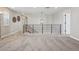 Spacious loft area with a decorative chandelier, neutral paint, and soft carpet at 9759 Waco St, Commerce City, CO 80022