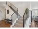 Modern staircase with sleek metal railings and neutral carpet at 9759 Waco St, Commerce City, CO 80022