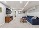 Cozy basement area features a large TV, comfortable blue sectional sofa, and stylish decor at 16662 W 61St Pl, Arvada, CO 80403