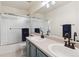 Bathroom features double sinks, blue cabinets and a glass enclosed shower at 16662 W 61St Pl, Arvada, CO 80403