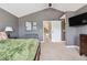 Spacious bedroom showcasing a sliding barn door and comfortable seating area at 16662 W 61St Pl, Arvada, CO 80403