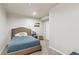 Comfortable bedroom featuring a tufted headboard bed, neutral decor, and ample closet space at 16662 W 61St Pl, Arvada, CO 80403