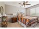Bedroom features a colorful patterned bedspread and ample natural lighting at 16662 W 61St Pl, Arvada, CO 80403