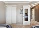 Bedroom showcasing a mirrored closet door and an adjacent bedroom entry at 16662 W 61St Pl, Arvada, CO 80403