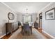 Elegant dining room featuring hardwood floors, a chandelier, and ample natural light at 16662 W 61St Pl, Arvada, CO 80403
