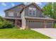 Charming two-story home with a three-car garage, well-manicured lawn, and inviting curb appeal at 16662 W 61St Pl, Arvada, CO 80403
