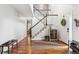 Spacious foyer with hardwood floors, a staircase, and a view into the living areas at 16662 W 61St Pl, Arvada, CO 80403