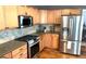 Well-equipped kitchen featuring stainless steel appliances and wood cabinets at 16662 W 61St Pl, Arvada, CO 80403