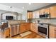 Well-equipped kitchen with stainless steel appliances and views of the living area at 16662 W 61St Pl, Arvada, CO 80403