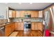 Bright kitchen with stainless steel appliances and hardwood floors at 16662 W 61St Pl, Arvada, CO 80403