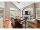 Bright living room featuring a fireplace, large windows, and hardwood floors at 16662 W 61St Pl, Arvada, CO 80403