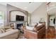 Cozy living room with a fireplace, built-in shelves, and hardwood floors at 16662 W 61St Pl, Arvada, CO 80403