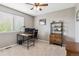 Well-lit office space with large window, modern desk, and decorative shelving at 16662 W 61St Pl, Arvada, CO 80403
