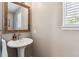 Pedestal sink in powder room with neutral paint and decor at 16662 W 61St Pl, Arvada, CO 80403