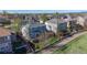 Aerial view of a two-story home with a deck, fenced yard, and solar panels at 9567 W 107Th Dr, Broomfield, CO 80021