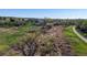 Aerial view of natural open space with trees, grasses, a walking path and neighborhood homes in the distance at 9567 W 107Th Dr, Broomfield, CO 80021