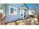 Exterior view of the home from back deck, featuring light blue siding and views of the backyard at 9567 W 107Th Dr, Broomfield, CO 80021