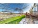 Backyard view with stone walkway, a wooden deck with stairs, and an open space with a walking path at 9567 W 107Th Dr, Broomfield, CO 80021