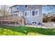 Backyard view with a wooden deck, grass, stepping stones, and light blue siding on the two-story home at 9567 W 107Th Dr, Broomfield, CO 80021