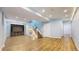 Finished basement with wood-look flooring, bright windows, and a staircase leading to the upper level at 9567 W 107Th Dr, Broomfield, CO 80021
