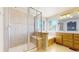 Bright bathroom featuring a shower with glass doors, soaking tub, tile floors, and a double vanity at 9567 W 107Th Dr, Broomfield, CO 80021