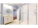 Bright bathroom featuring a glass shower, white marble floors and a vanity at 9567 W 107Th Dr, Broomfield, CO 80021