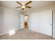Bedroom with neutral carpet, ceiling fan, and a double-door closet at 9567 W 107Th Dr, Broomfield, CO 80021