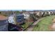 Two-story home with blue siding, wood deck, lawn, and white fence bordering a walking path on a sunny day at 9567 W 107Th Dr, Broomfield, CO 80021