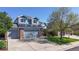Beautiful two-story home with gray siding, solar panels, brick accents and an attached two-car garage at 9567 W 107Th Dr, Broomfield, CO 80021