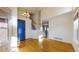 Entryway featuring hardwood floors, a blue front door, and a staircase leading to the upper level at 9567 W 107Th Dr, Broomfield, CO 80021