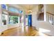 Bright foyer with hardwood floors, staircase, large windows and high ceilings that create a welcoming ambiance at 9567 W 107Th Dr, Broomfield, CO 80021