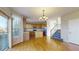 Spacious kitchen with wooden cabinets, hardwood floors, stainless steel appliances, and stairs nearby at 9567 W 107Th Dr, Broomfield, CO 80021