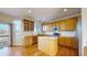 Bright kitchen with wood cabinets, stainless steel appliances, center island, and sliding doors to the deck at 9567 W 107Th Dr, Broomfield, CO 80021
