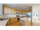 Well-equipped kitchen featuring wood cabinetry, stainless steel appliances, and a functional center island at 9567 W 107Th Dr, Broomfield, CO 80021